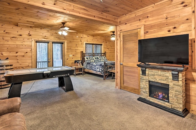 recreation room featuring wood walls, a fireplace, carpet floors, and wooden ceiling