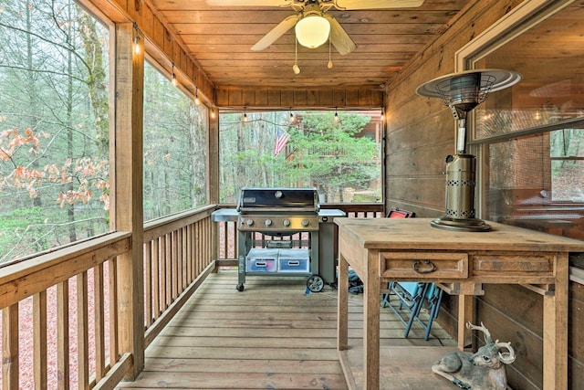 wooden terrace featuring area for grilling and ceiling fan