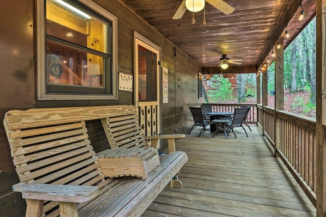 wooden terrace with ceiling fan and covered porch