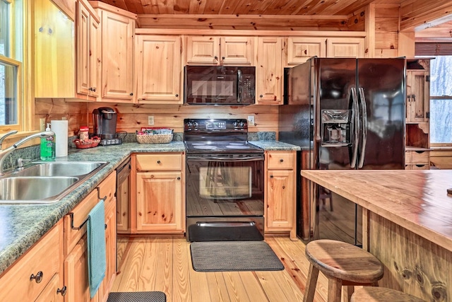 kitchen featuring wooden ceiling, sink, black appliances, and light hardwood / wood-style flooring