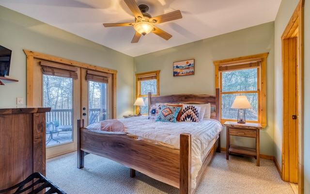 carpeted bedroom with access to exterior, ceiling fan, and french doors