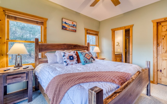 bedroom featuring multiple windows, light carpet, and ceiling fan