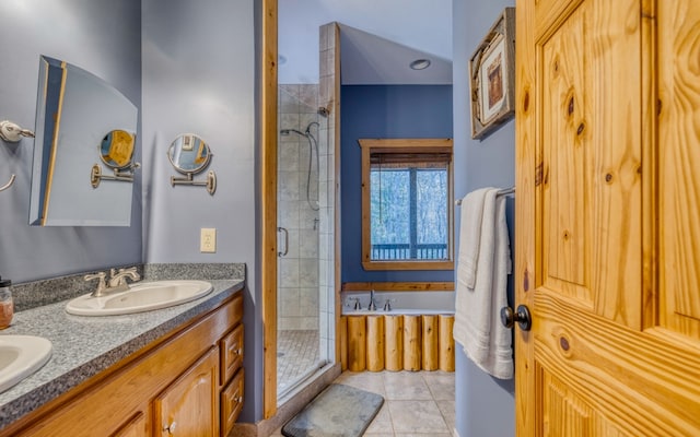 bathroom featuring independent shower and bath, double vanity, and tile floors