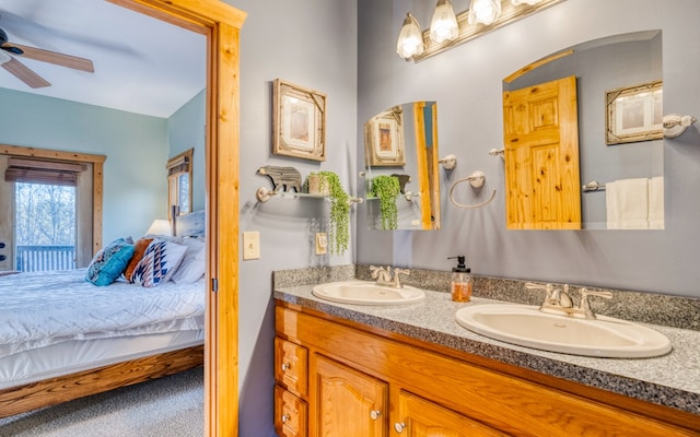 bathroom with double sink, ceiling fan, and vanity with extensive cabinet space