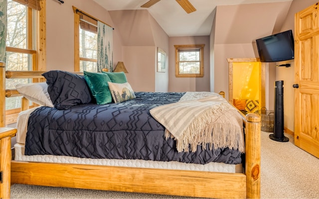 bedroom featuring light carpet, lofted ceiling, and ceiling fan