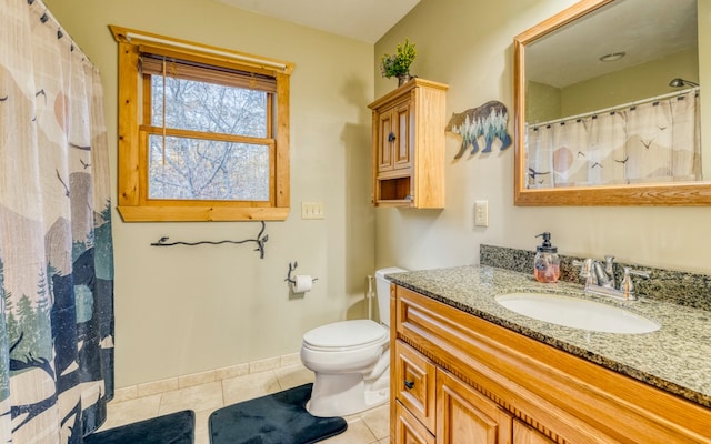 bathroom featuring tile floors, vanity with extensive cabinet space, and toilet