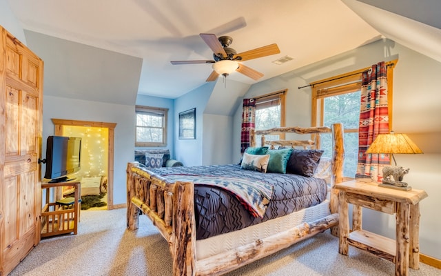 bedroom with ceiling fan, light carpet, and vaulted ceiling