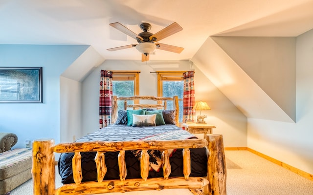 bedroom featuring light carpet, lofted ceiling, and ceiling fan