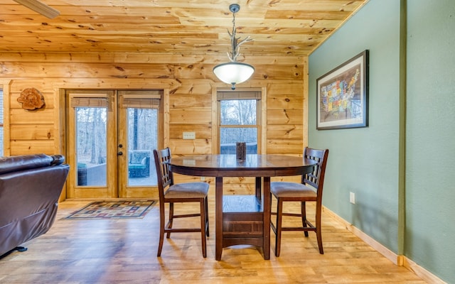 dining space featuring french doors, wood ceiling, and light wood-type flooring