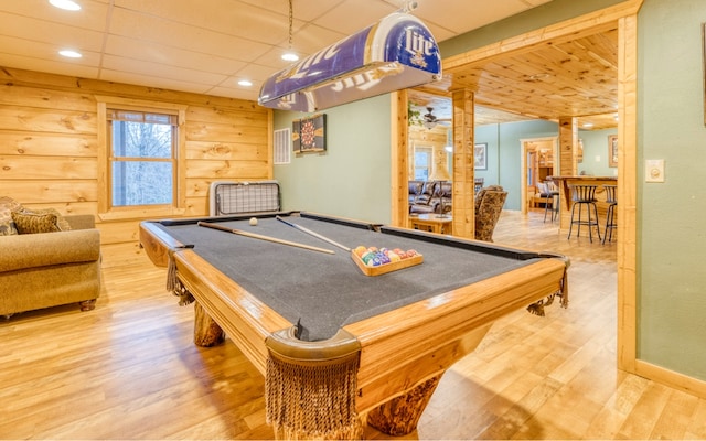 recreation room with billiards, light hardwood / wood-style floors, decorative columns, and a drop ceiling