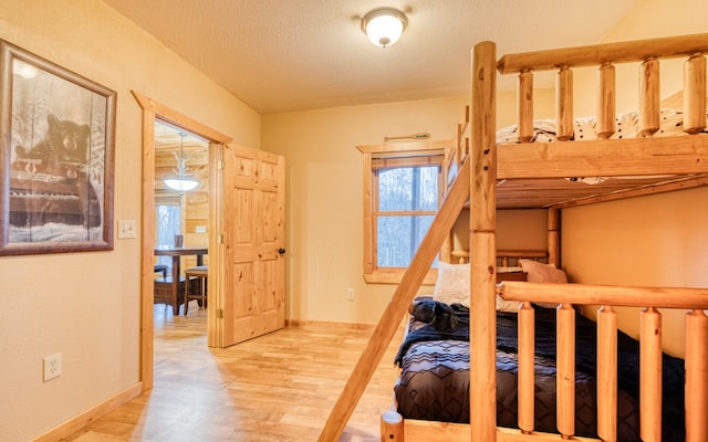 bedroom featuring a textured ceiling and light wood-type flooring