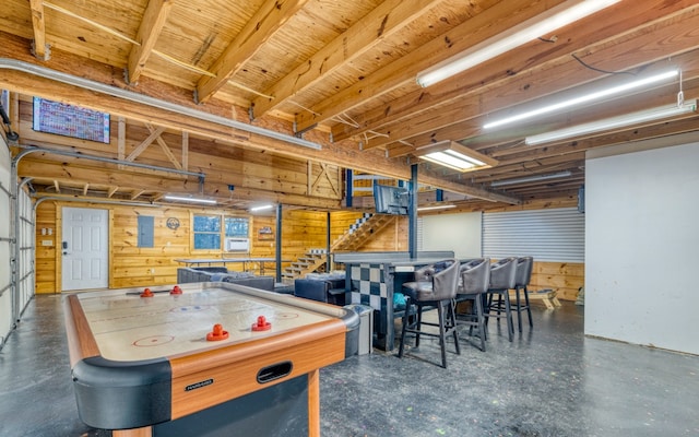 recreation room with wooden walls