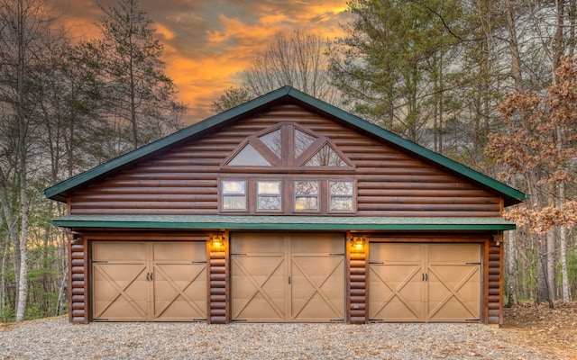 view of garage at dusk