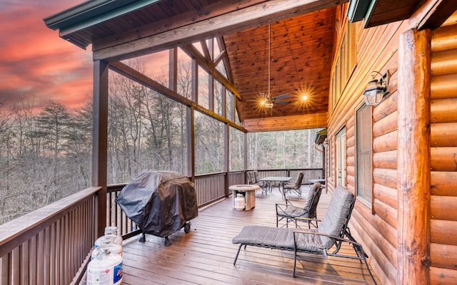 deck at dusk featuring grilling area and ceiling fan