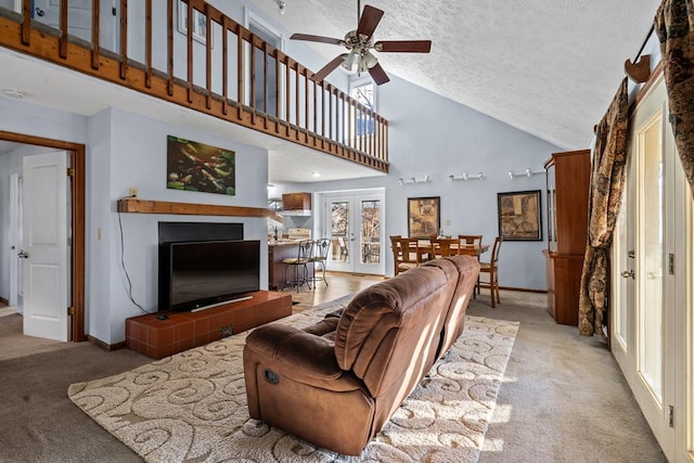 living room featuring light carpet, french doors, high vaulted ceiling, and a textured ceiling