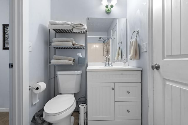 bathroom with vanity, toilet, and walk in shower