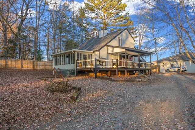 view of front of house with a wooden deck and a sunroom