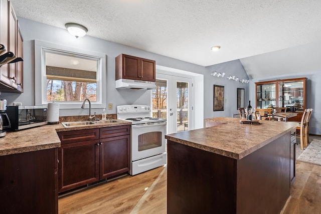 kitchen with lofted ceiling, light hardwood / wood-style floors, white electric stove, and a kitchen island