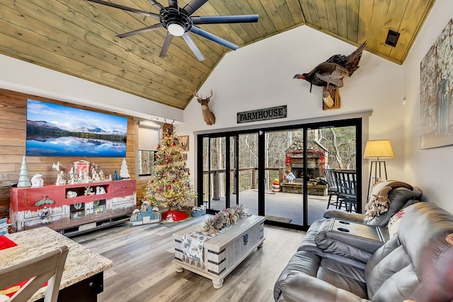 living room featuring ceiling fan, high vaulted ceiling, wood ceiling, and wood-type flooring