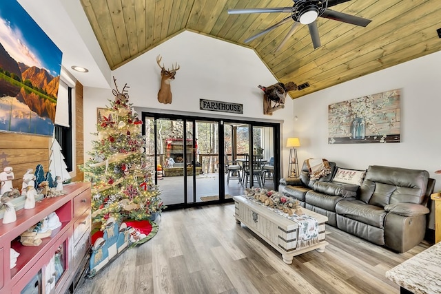 living room with hardwood / wood-style floors, high vaulted ceiling, ceiling fan, and wood ceiling