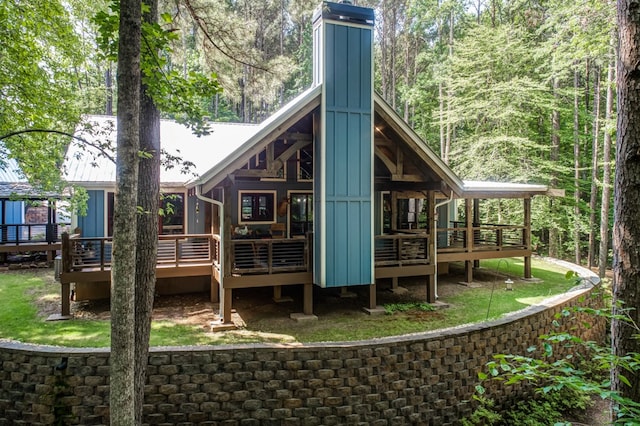 back of house featuring a wooden deck