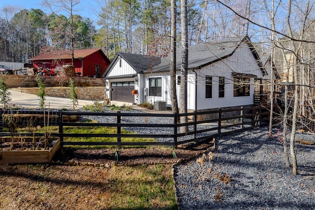 view of front of house featuring central AC unit and a garage