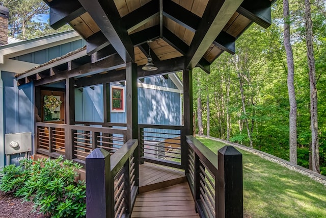 wooden deck with a lawn