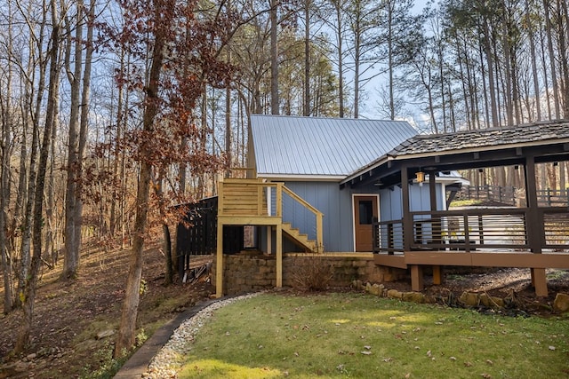 exterior space featuring a lawn and a deck