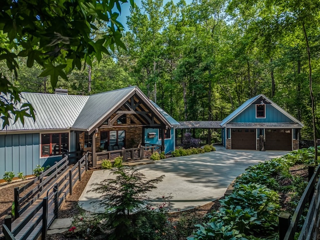 view of front of property featuring an outbuilding, a garage, and covered porch