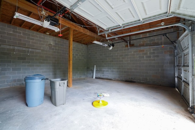 289 12 Point Rd, Blairsville, GA 30512 - garage featuring a garage door opener and concrete block wall