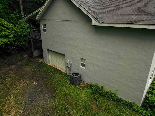289 12 Point Rd, Blairsville, GA 30512 - view of home's exterior with roof with shingles, central AC, stucco siding, and an attached garage