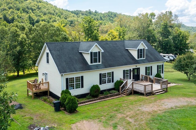 cape cod house featuring a front yard and a deck