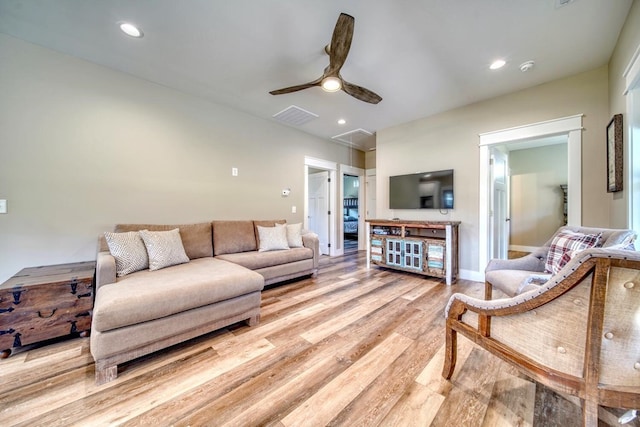 living room with ceiling fan and light wood-type flooring