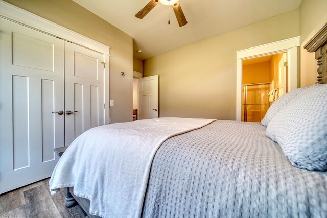 bedroom with ceiling fan, wood-type flooring, and a closet