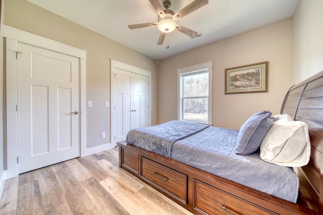 bedroom featuring a closet, light hardwood / wood-style flooring, and ceiling fan