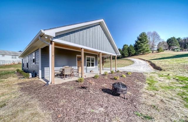 view of side of home with a patio and a fire pit