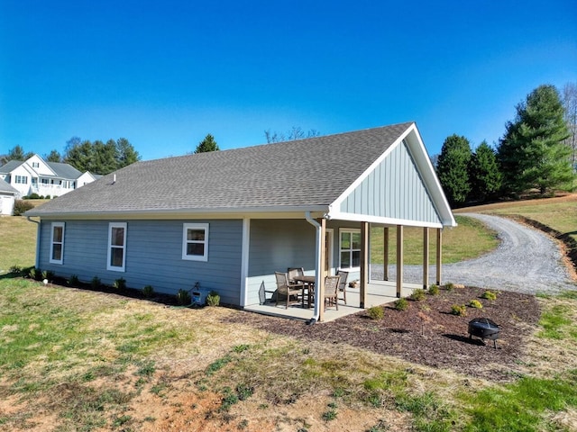 back of house featuring a lawn and a patio area