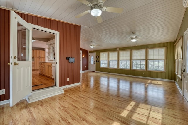 unfurnished living room with light wood-style floors, baseboards, and ceiling fan