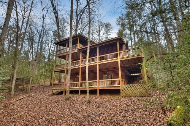 rear view of house with a deck and a balcony