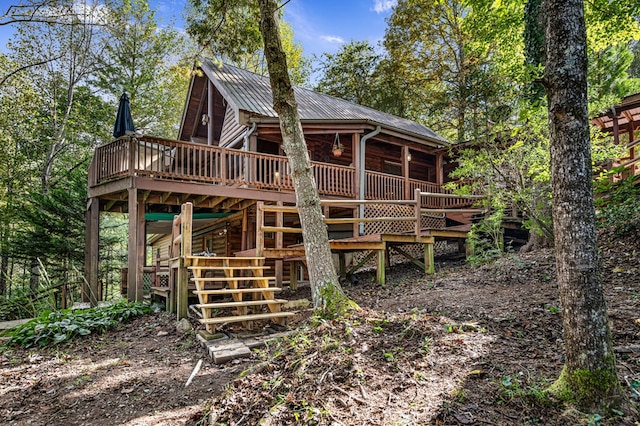 rear view of house featuring a wooden deck