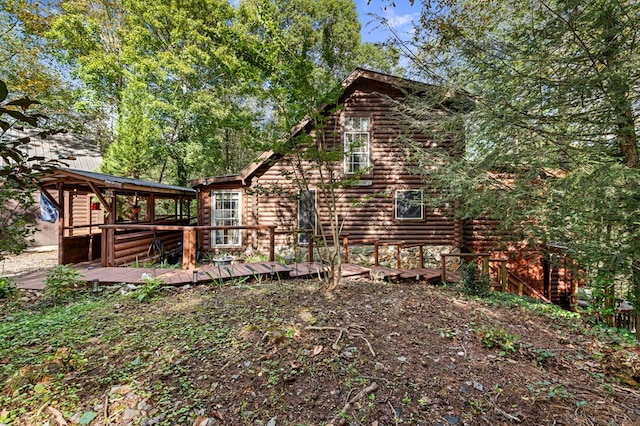 view of side of property featuring a wooden deck