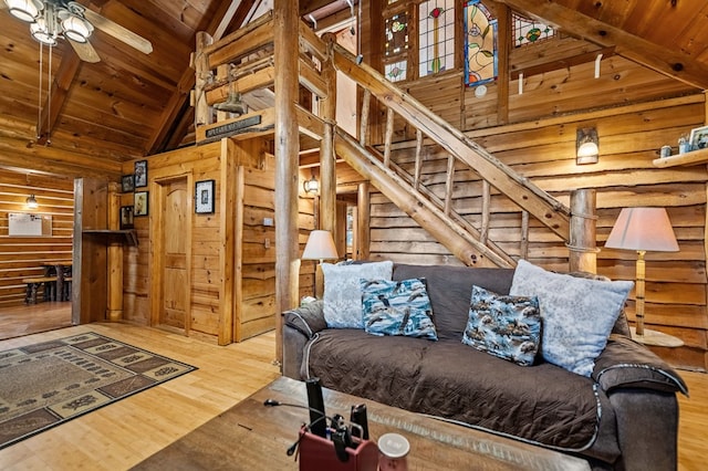 living room featuring wood ceiling, hardwood / wood-style flooring, beam ceiling, high vaulted ceiling, and ceiling fan