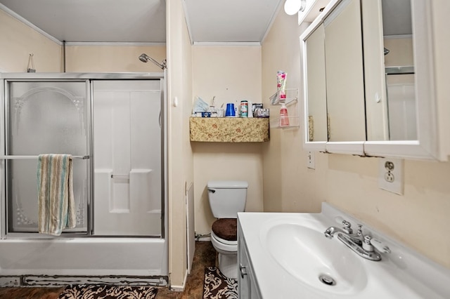 full bathroom with enclosed tub / shower combo, vanity, and toilet