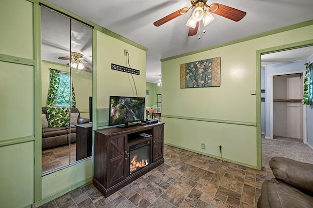 living room featuring ornamental molding and ceiling fan