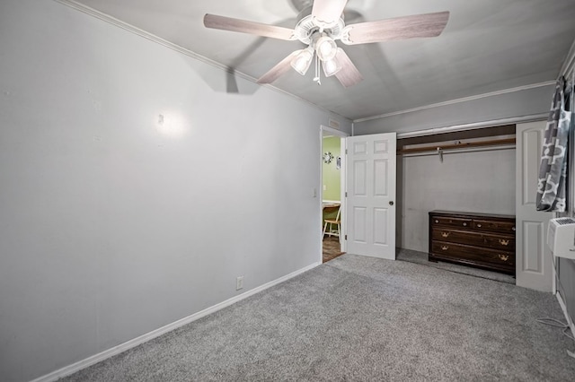 unfurnished bedroom featuring ceiling fan, ornamental molding, a closet, and carpet flooring