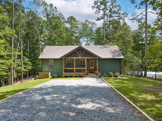 view of front of home featuring covered porch and a front lawn