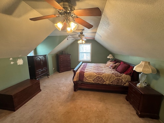 bedroom featuring lofted ceiling, a textured ceiling, light colored carpet, and ceiling fan