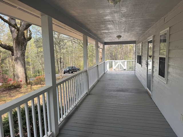 wooden terrace featuring covered porch