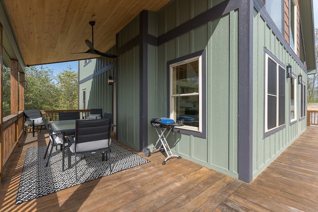 wooden deck featuring grilling area and ceiling fan