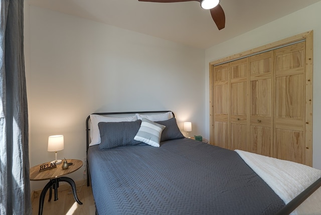 bedroom featuring a closet, wood-type flooring, and ceiling fan